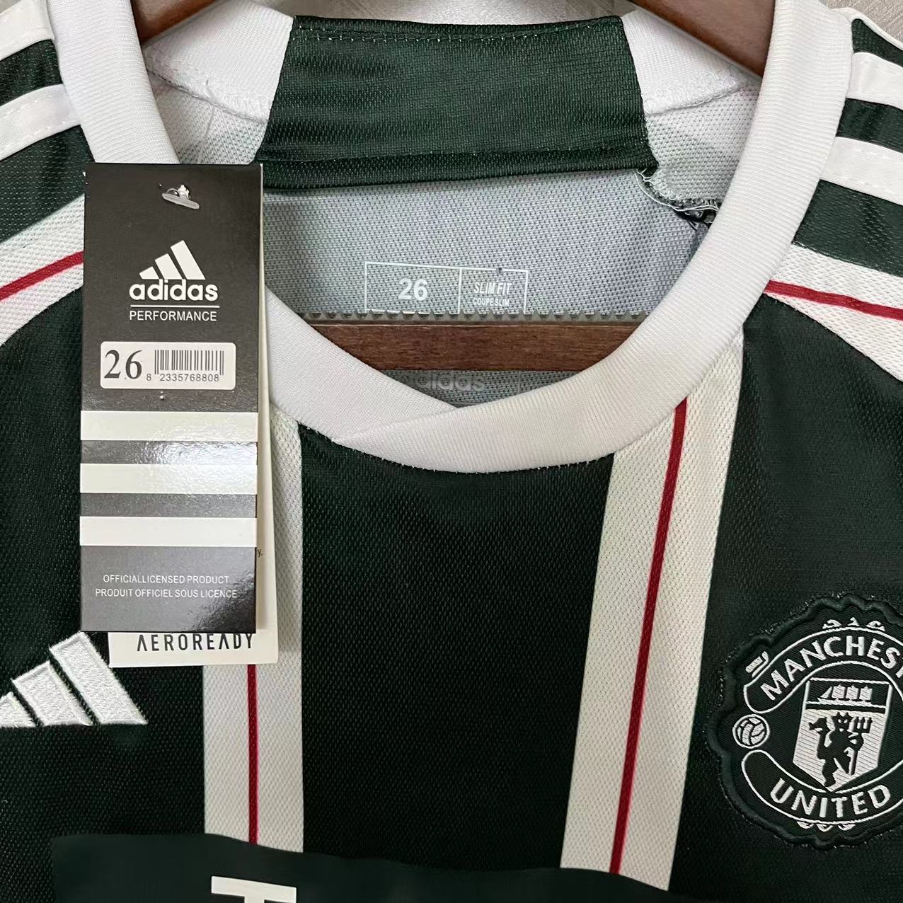 KIT INFANTIL MANCHESTER UNITED AWAY 23/24